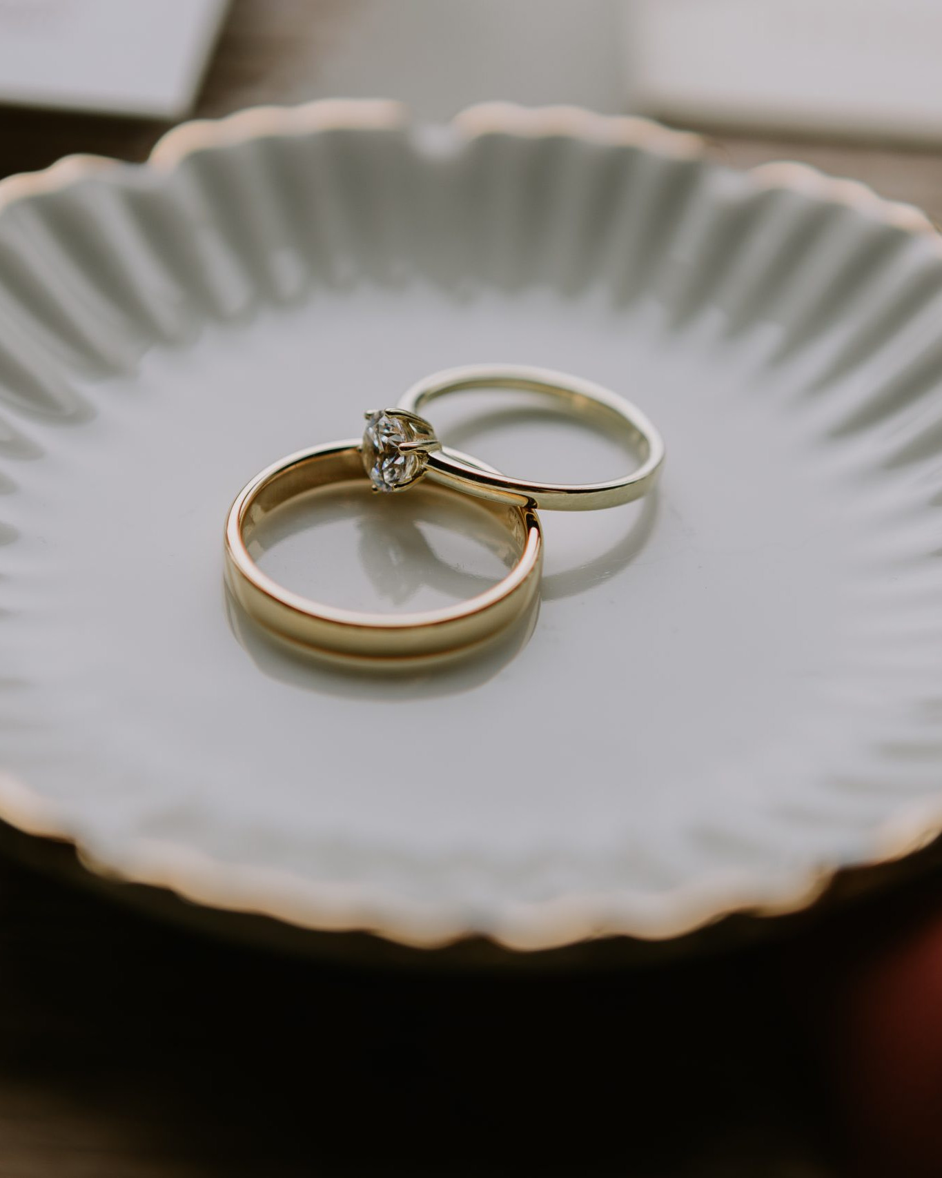 Herren Gelbgoldring und Frauen Weissgoldring mit Brillant in einer runden Schale liegend